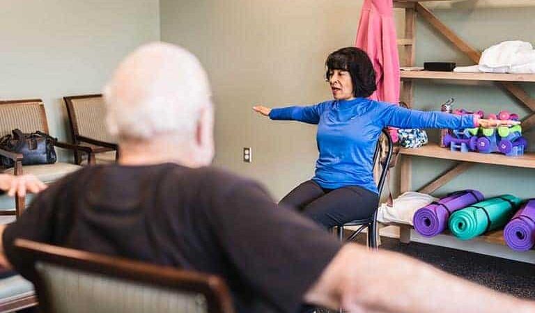 Yoga instructor leading a stretching class